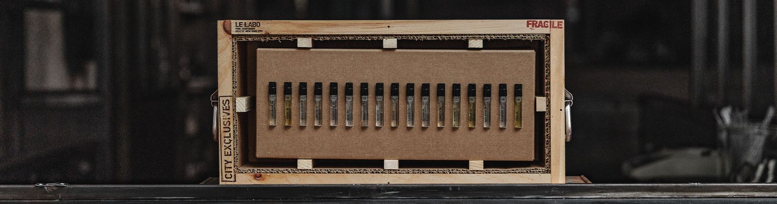Le Labo wooden crate holding the full fine fragrance collection in discovery sizes