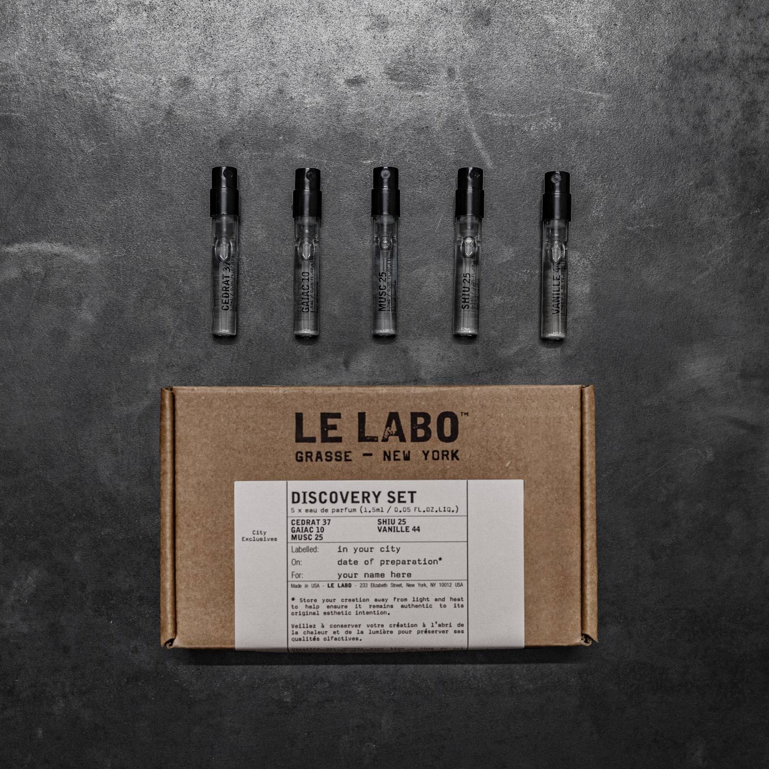 Le Labo discovery set kraft box with five sample vials on dark concrete