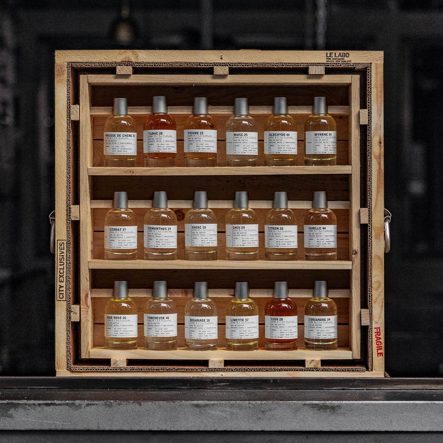Le Labo fine fragrance collection in a wooden crate, bottles hand-labelled