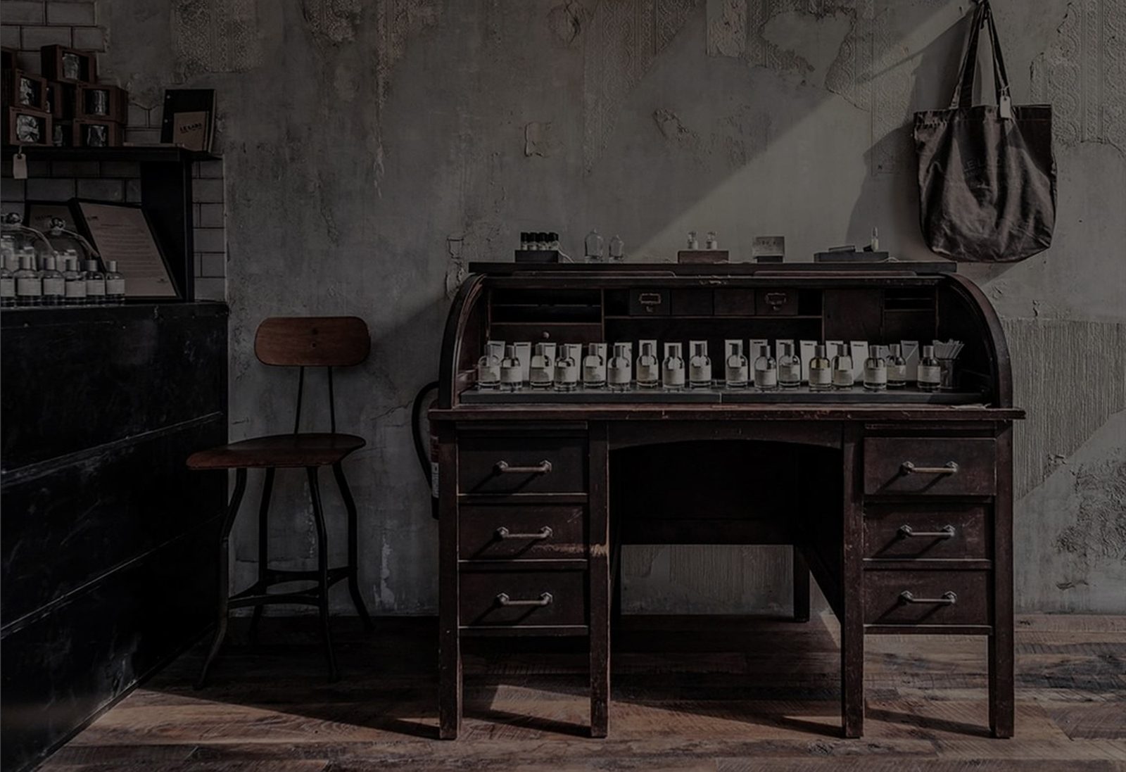 Le Labo lab counter in New York with glass bottles, beakers and a hand-filling station